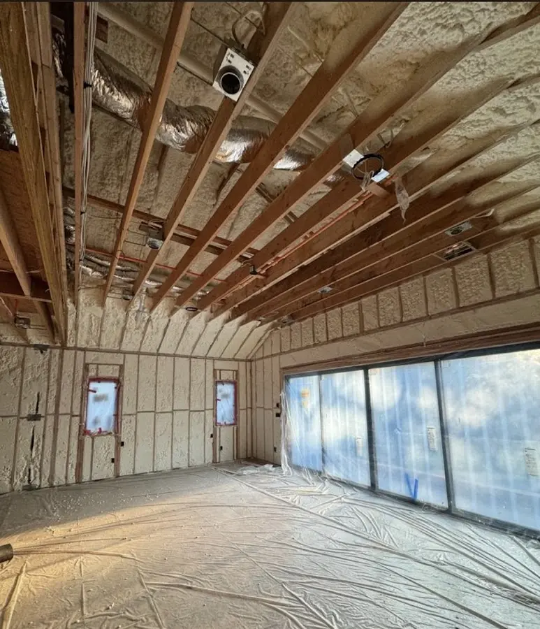 Interior walls and ceiling insulated with spray foam during new construction in West Long Branch